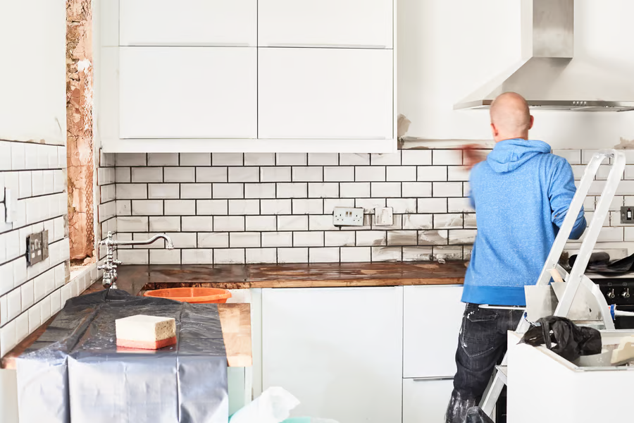 Contractor updating a kitchen during home improvement services.