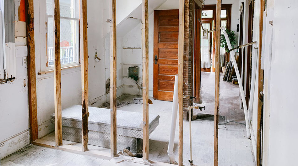 A room featuring wooden framing and a door, showcasing a simple and rustic interior design.